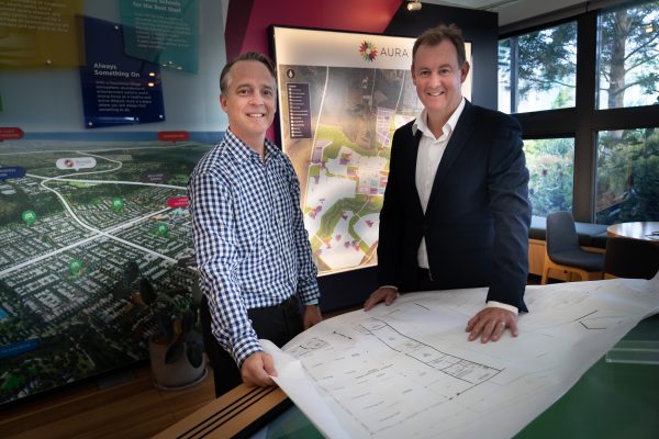 Sunshine Mitre 10 general manager Neil Hutchins with Stockland Senior Economic Development Manager Matthew Byrne reviewing plans for the Aura Business Park - photo by Reflected Image PR