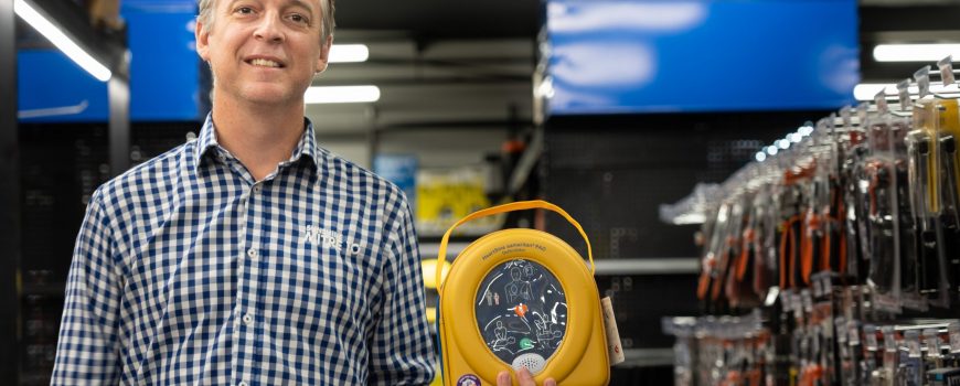 Sunshine Mitre 10 general manager Neil Hutchins with one of the defibrillators, now in every Sunshine Mitre 10 store - hoz